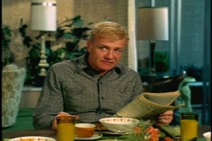 Reading the paper, Bill notices that the rodeo is in town and decides that will be the first of the week's activities. (That's some cute mid-century dinnerware on the table.)