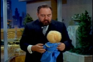 To his credit, his first instinct is to sneak the doll back onto the chair, but he's interrupted by Bill and the kids entering the room.