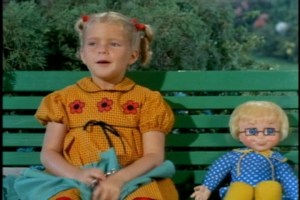 Then she goes back to cutting out fabric for doll clothes--because she's a GIRL. Are you starting to sense the comical contrast here?