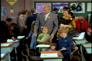 Freddie ends up accompanying the family to school. While she may seem overdressed in her dead-animal regalia, the kids and most of their classmates are pretty decked out, too. Who knew that NYC public schools were so formal in the 1960s?