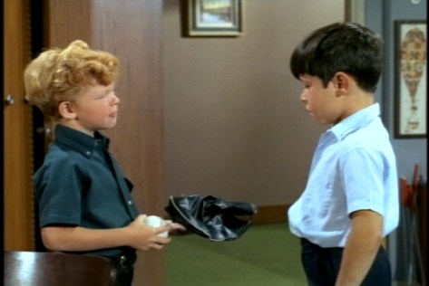 Jody, excited to have another boy around the house, shows off is Willie-Mays-signed baseball lets Timmy use his catcher's mitt.