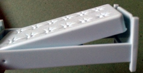 See how pushing down on the lever makes the mattress spring up? Unfortunately, my game came without a key game piece--the actual pillows. My daughter and I substituted cotton balls when we played the game.