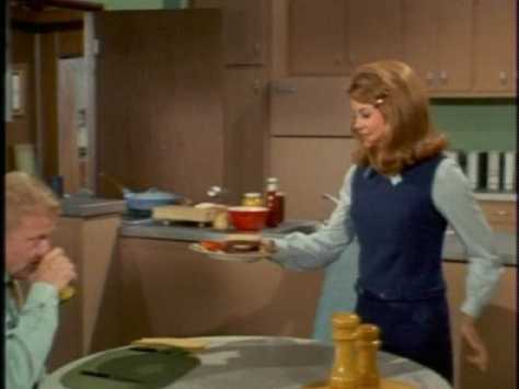 He heads to the kitchen, excited to eat "a real American hamburger with onions and junk."