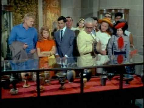 A group with an official tour guide follows them from place to place, reciting the same language.