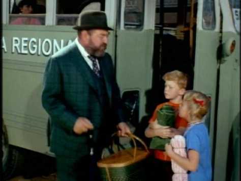 French tells the kids to get on the Sitges bus while he runs back to get the doll.