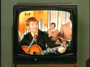 This guy is singing a song with lyrics that include, "I never shave or comb my hair, but I do think of her."