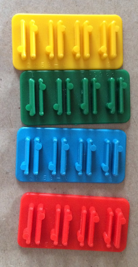 The cardboard caricatures slide into these plastic bases.